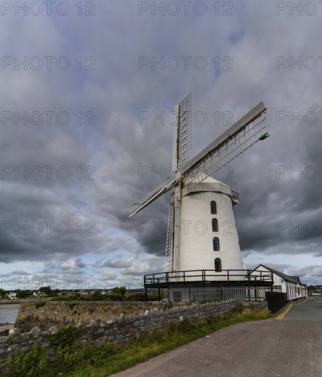 Blennerville, Ireland, 5 August, 2022: view of the historic Blennerville Windmill in Tralee Bay in western Ireland under stormy skies, Europe