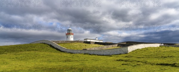 A view of the historic harbor lighthouse at St. John's Point in Donegal Bay in the north of Ireland