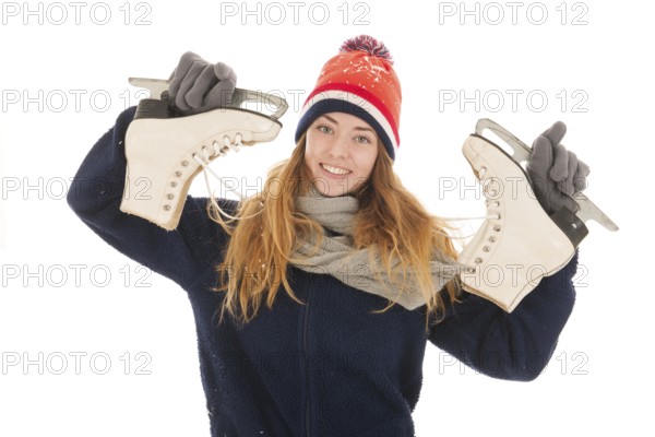 Attractive Dutch woman is ahving fun with ice skates isolated over white background