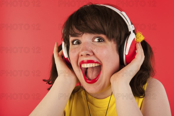 Young woman is exciting about hearing good music