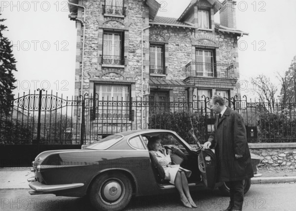 Volvo P1800. A sports car manufactured by Volvo Cars wtih start 1961 and ending 1973. Styling was by swedish designer Pelle Pettersson. The car was indroduced at the Geneva Motor Show in 1961. The P1800 became widely known when driven by then future James Bond actor Roger Moore as Simon Templar in the television series The Saint. Pictured here swedish actress Gunnel Lindblom with her husband outside their villa in France with their Volvo P1800. 1965