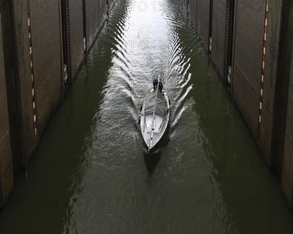 Maasbracht, Limburg, The Netherlands, 04 20 2022, Large sluice gate with a small vessel passing by, Europe