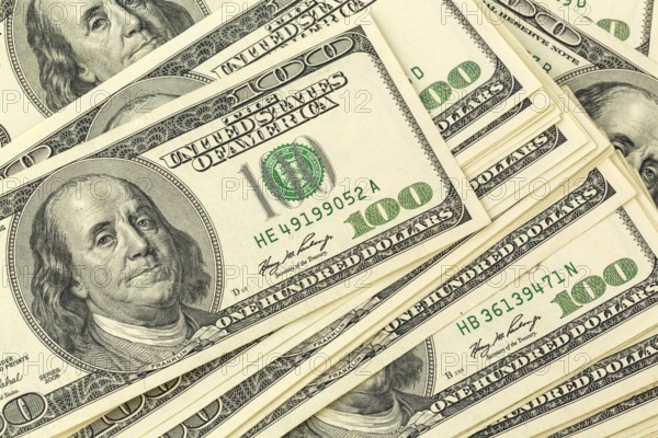 Many American dollar banknotes. Symbolic photo for debt and wealth Austria