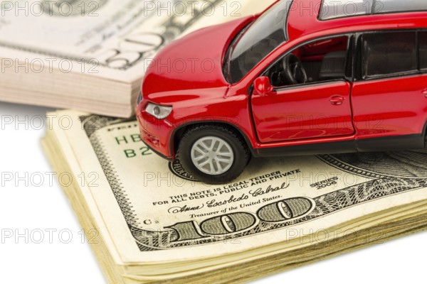 A car is written on dollar notes. Costs for car purchase, petrol, insurance and other car costs Austria