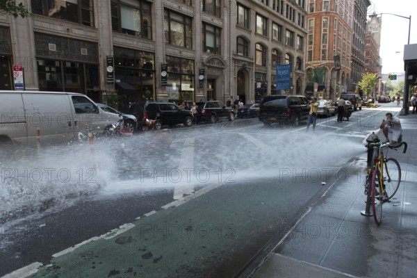 Spray of water from broken johnny pump on Manhattan, New York, USA, North America