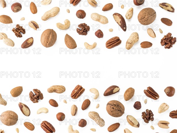 Pattern of nuts mix with copy space. Various nuts isolated on white. Pecan, macadamia, brazil nut, walnut, almonds, hazelnuts, pistachios, cashews, peanuts, pine nuts. Top view or flat-lay. Copy space