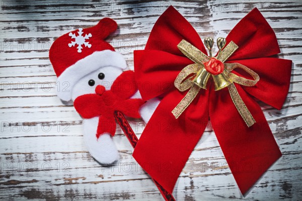 Santa Claus toy red bow on vintage wooden board celebrations concept