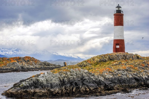 Les Eclaireurs lighthouse against a dramatic sky and snowy peaks in Argentina