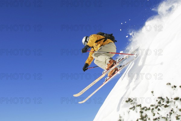 Skiers in action, skiing down the slope