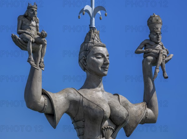 Imperia, a rotating, nine metre high concrete statue in the port of Constance, designed by Peter Link. The statue is a satirical reminder of the Council of Constance (1414-1418) . On her raised hands, the imperialist carries two small naked men, in her right hand a king with crown and orb, in her left hand a man with a papal tiara and crossed legs, Constance, Baden-Württemberg, Germany, Europe