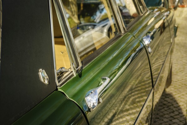 Lisbon, Portugal, Jan 20, 2024: Details of side view of classic green Rover P6 Series II or Mark II 2000 TC executive car, 4 door saloon, parked on a cobblestone path in a city. Doors, handles, emblem and open quarter window in selective focus, Europe