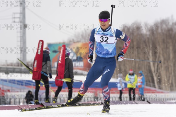 Korean sportsman biathlete Yang Seon Jik skiing on snow distance biathlon stadium during Junior biathlon competitions East of Cup. Kamchatka Peninsula, Russian Far East, April 12, 2019