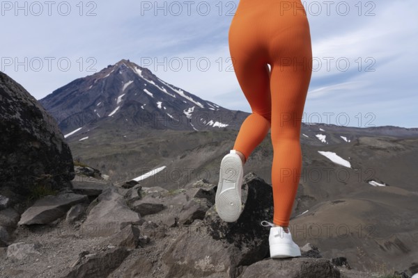 Closeup woman in figure hugging sports leggings showing off buttocks and legs. Athletic woman doing outdoor fitness training and her gluteal and thigh muscles are clearly defined. Rear view of body