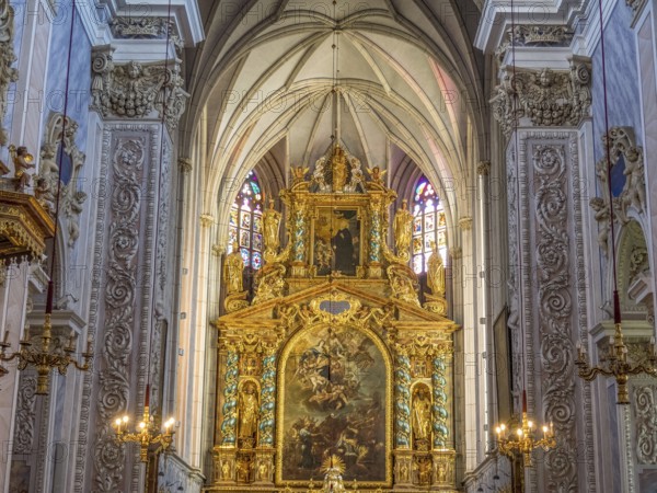 Gold-decorated altar in the Baroque church interior with ornate paintings and decorative details on the walls, Dürnstein, Wachau, Danube, Austria, Europe
