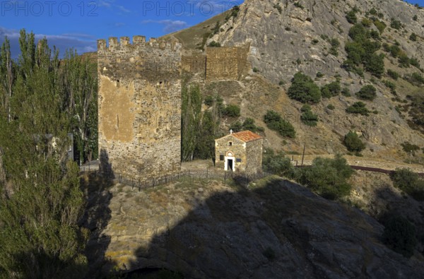 Medieval tower and old Christian temple near the ruins of the Genoese fortress in Sudak, Crimea