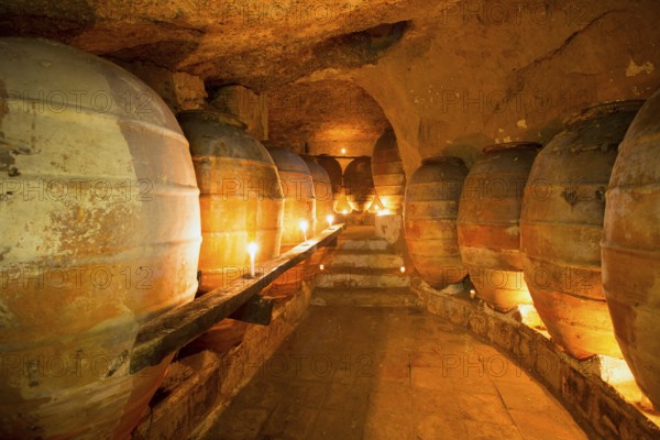 Antique winery in Spain with clay vessels terracotta amphora pots Mediterranean tradition with candlelight