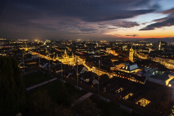 Sunset over the old town of Graz, view from the Schlossberg, illuminated tower of the Franciscan church, illuminated town hall, roofs in the old town, blue hour, Graz, Styria, Austria, Europe