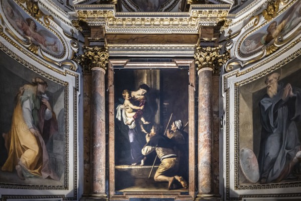 Altarpiece with the Madonna di Loreto by the Italian Baroque master Caravaggio in the Cavalletti Chapel of the Church of St Agostino in Campo Marzio near Piazza Navona in Rome