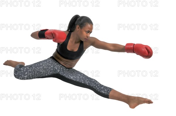 Beautiful young black woman wearing a pair of boxing gloves