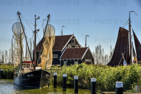 Enkhuizen, the Netherlands, September 2020. The Zuiderzeemuseum, an open air museum at the shore of the IJsselmeer with traditional Dutch fishermen cottages and flat bottomed fishing boats.
