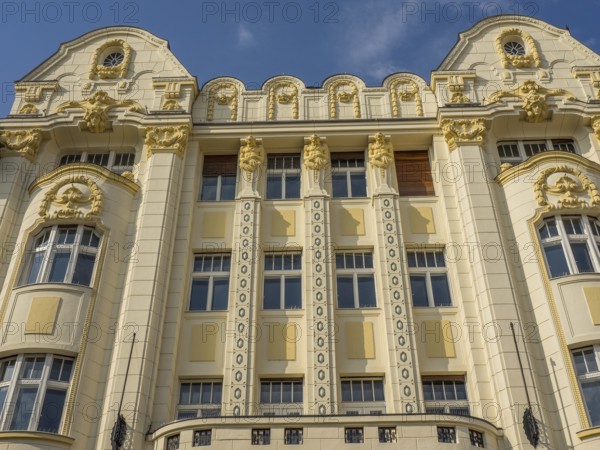 Historic building with ornate façade, stucco work and gilded elements under a blue sky, bratislava, slovakia