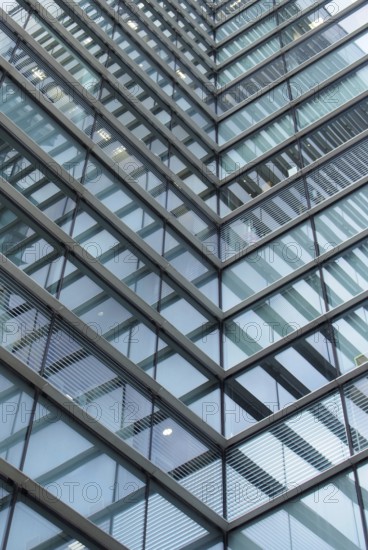 A full frame modern office architecture abstract with geometric angular reflected shapes and lines in blue glass windows