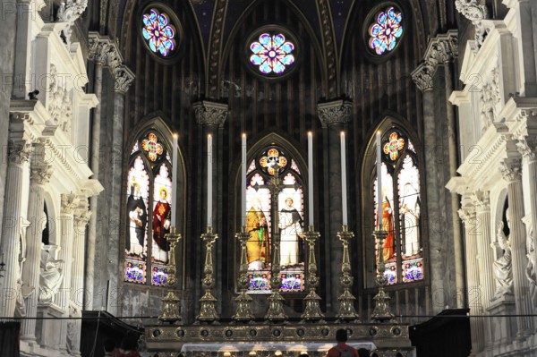 Interior view of the Gothic basilica, construction began at the end of the 13th century, Santa Maria sopra Minerva, Rome, Lazio region, Italy, Gothic altar with luminous stained glass windows and burning candles, Rome, Lazio, Italy, Europe