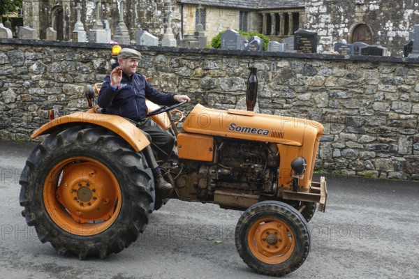 Old tractor Someca in front of church and chapel Sainte Nonne, vintage car meeting Dirinon, department Finistere Penn ar Bed, region Bretagne Breizh, France, Europe