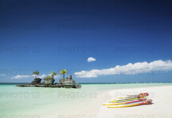 Tropical beach christian shrine and tourist canoes on boracay island philippines