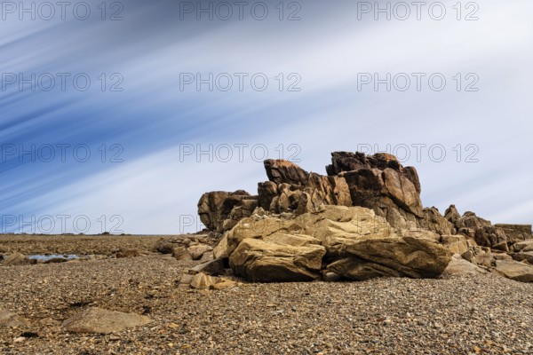 Rock formation against sky in Sillon de Talbert area in Brittany. Long exposure against moving clouds