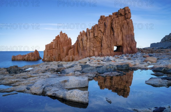 A view of the red rocks of Arbatax with reflections in tidal pools in the foreground