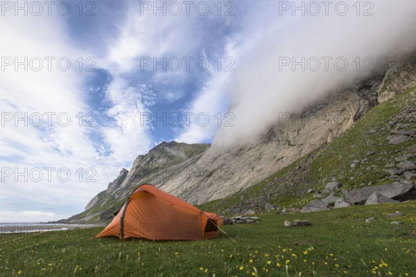 Tent at the foot of a rock face, Buneset, Moskenesöya, Lofoten, Nordland, Norway, July 2015, Europe