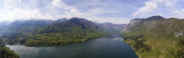 Aerial panorama of Bohinjsko jezero lake between mountains in Slovenia at spring