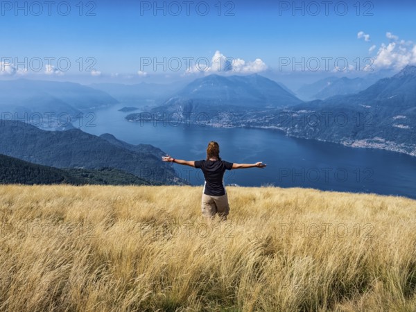 Woman walking in a prairie on Lake Como alps