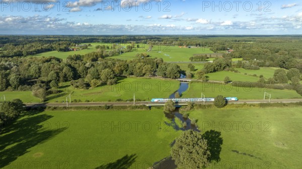 Aerial view of a train in a beautiful green landscape in eastern netherlands