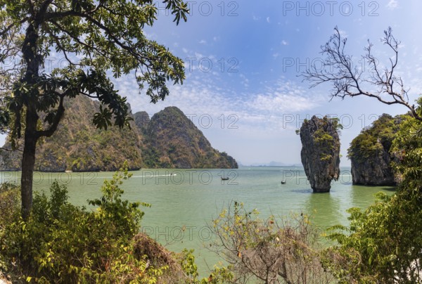 A colorful picture of the beautiful landscape of the James Bond Island and its iconic islet