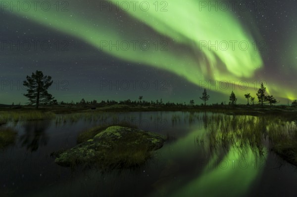 Northern Lights (Aurora borealis) reflected in a mountain lake, Gällivare, Norrbotten, Lapland, Sweden, October 2013, Europe
