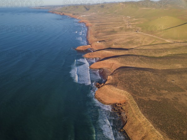 Aerial view on Legzira beach with arched rocks on the Atlantic coast at sunset in Morocco
