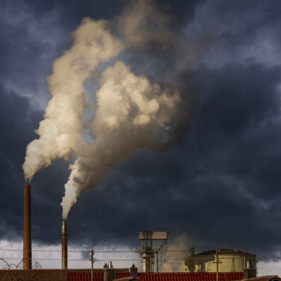 Dark smoke comming from the chimneys of an old factory
