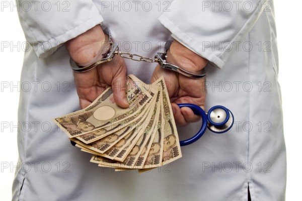 A doctor with Japanese YEN banknotes and handcuffs Austria