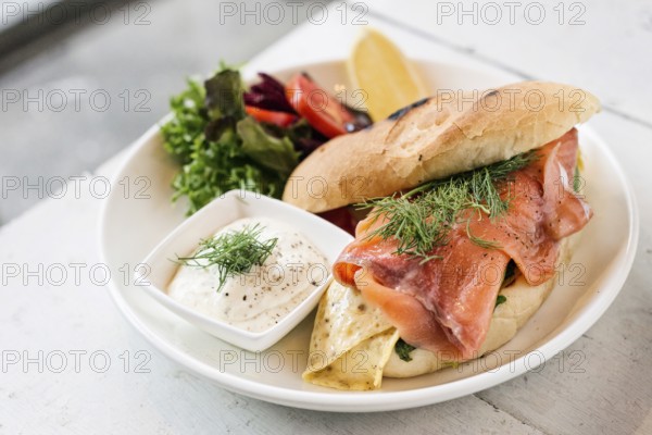 Scandinavian healthy fresh smoked salmon sandwich with egg and sour cream set meal