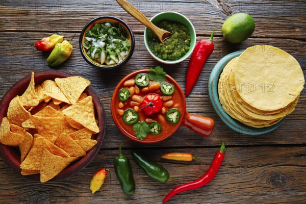 Frijoles charros mexican beans with chili pepper sides and tortillas
