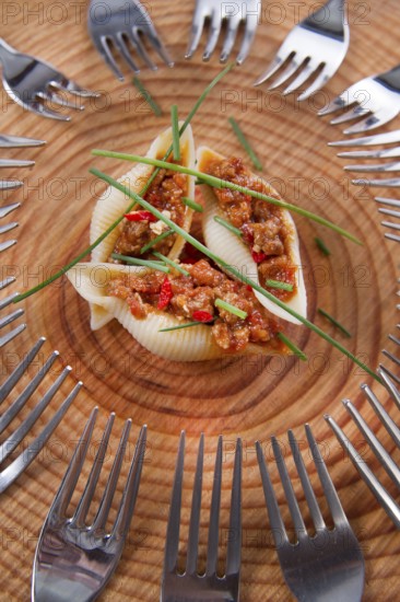 Presentation first plate of pasta shells with meat sauce and tomato