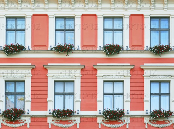 The Facade Of The Building With Flowers