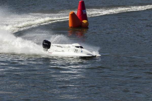 PESO DA REGUA, PORTUGAL - SEPTEMBER 15, 2024: White Powerboat Makes Sharp Turn with Splashes of Water during Race. Red Buoy. Formula 2 World Championship