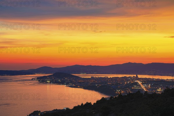 View of a city at dusk with vivid colours in the sky and reflecting water, Split, Dalmatia, Croatia, Europe