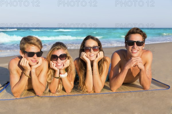 Beach friends together tourits portrait on the sand smiling happy