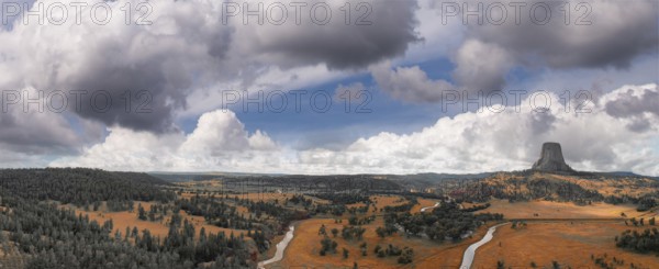 Panoramic aerial view of Devils Tower National Monument at sunset, Wyoming from a drone perspective