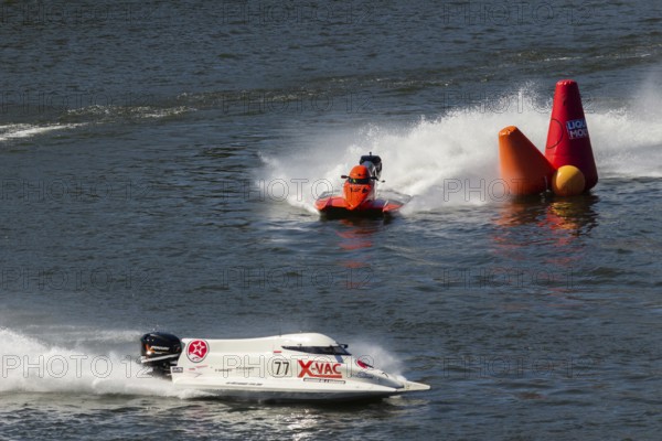 PESO DA REGUA, PORTUGAL - SEPTEMBER 15, 2024: Red and White Powerboats Go Fast with Splashes of Water during Race. Red Buoy. Formula 2 World Championship