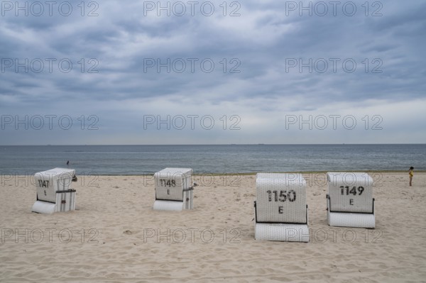 26.07.2024, Heringsdorf, Usedom, Mecklenburg-Western Pomerania, Germany, Europe, Clouds move over the empty sandy beach of the Baltic seaside resort of Heringsdorf with traditional beach chairs on the popular German holiday island on the Baltic Sea, Europe